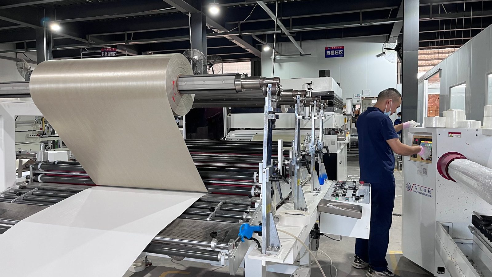QC operator at mica tape laminating line